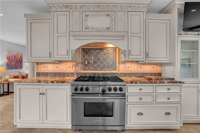 a stove top oven sitting inside of a kitchen