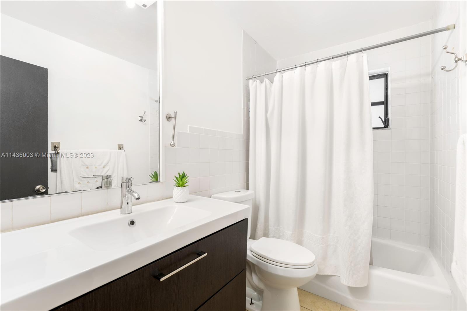 19260 Southwest 93rd Road Cutler Bay, FL 33157 - Photo 9 of 19 a bathroom with a sink a toilet and a mirror