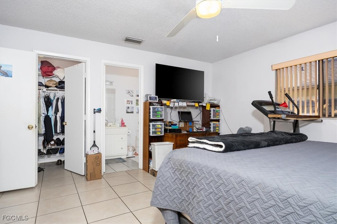 7261 Albany Road Fort Myers, FL 33967 - Photo 18 of 27 a bedroom with furniture and a flat screen tv