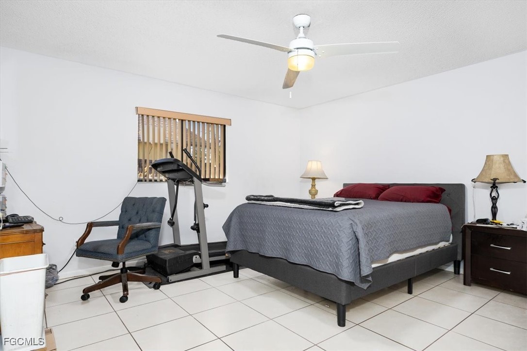 7261 Albany Road Fort Myers, FL 33967 - Photo 21 of 27 a bedroom with a bed and a chandelier