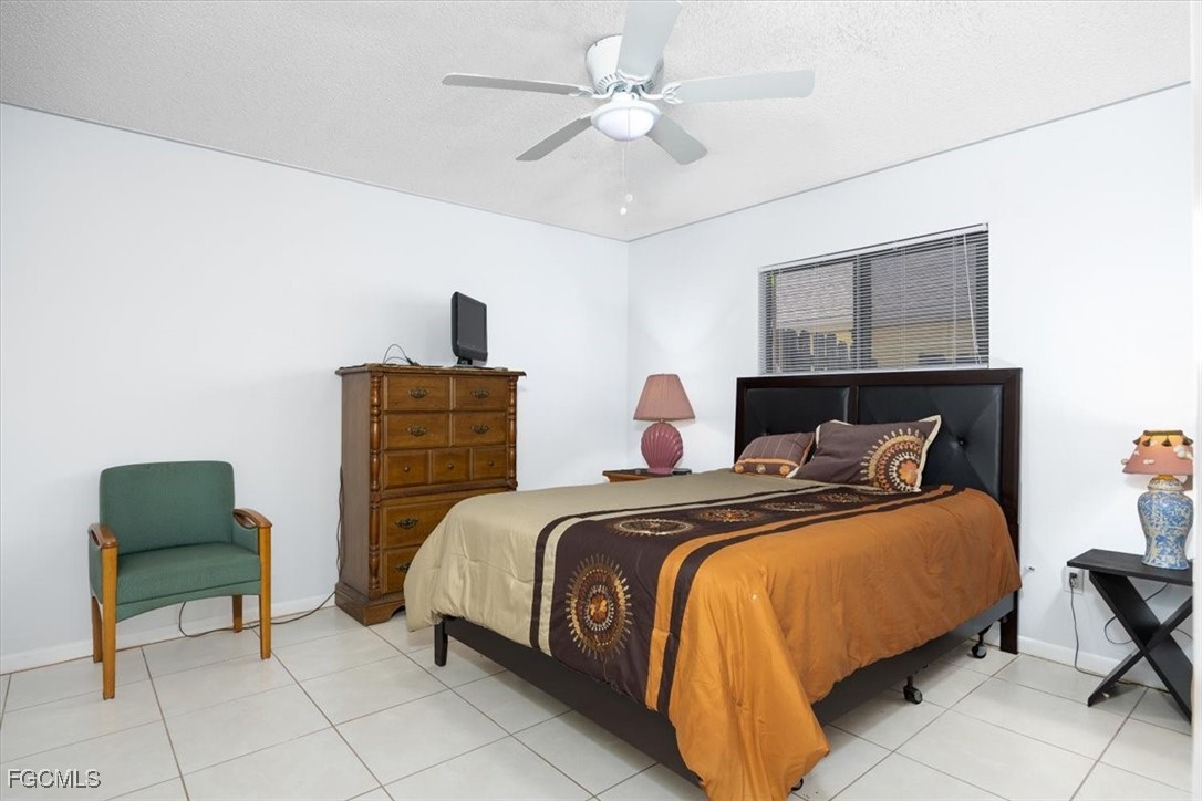 7261 Albany Road Fort Myers, FL 33967 - Photo 22 of 27 a bedroom with a bed and a chair
