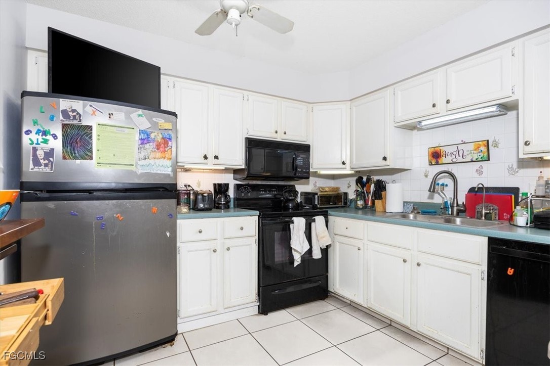 7261 Albany Road Fort Myers, FL 33967 - Photo 26 of 27 a kitchen with stainless steel appliances a stove microwave and a refrigerator