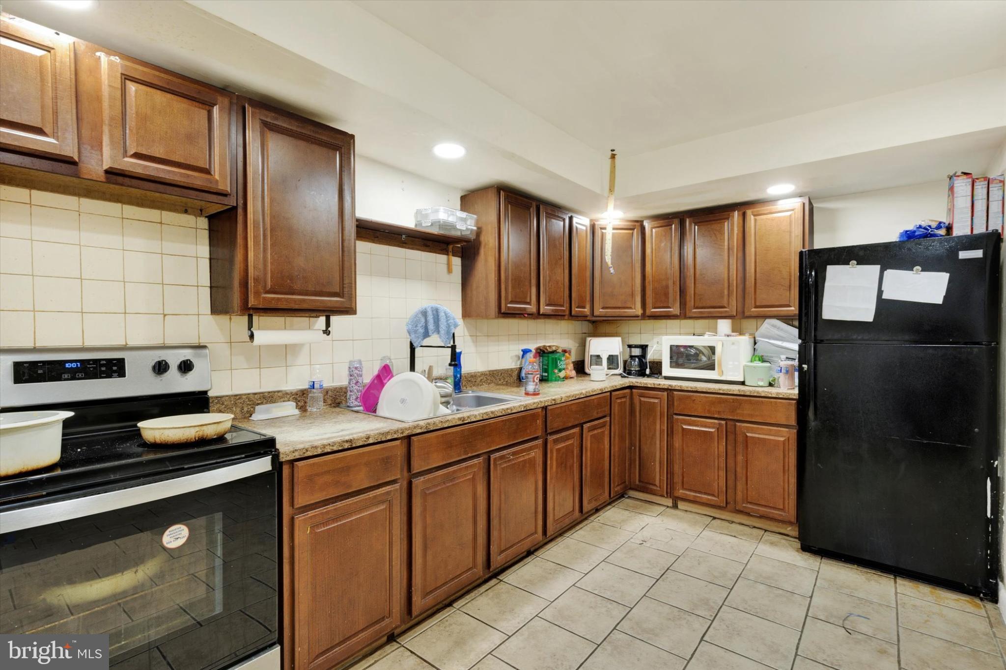 1211 Wabank Street Lancaster, PA 17603 - Photo 5 of 26 a kitchen with stainless steel appliances granite countertop a refrigerator sink and cabinets