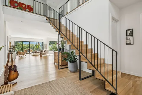 a view of entryway and hall with wooden floor