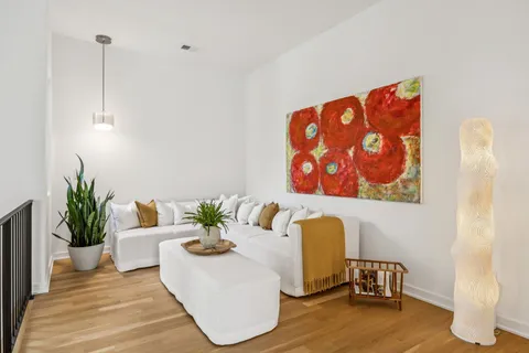 a living room with furniture and wooden floor
