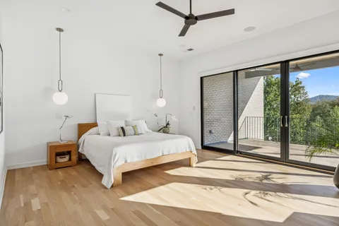 a bedroom with bed and large window