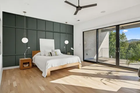 a bedroom with a large bed and a chandelier