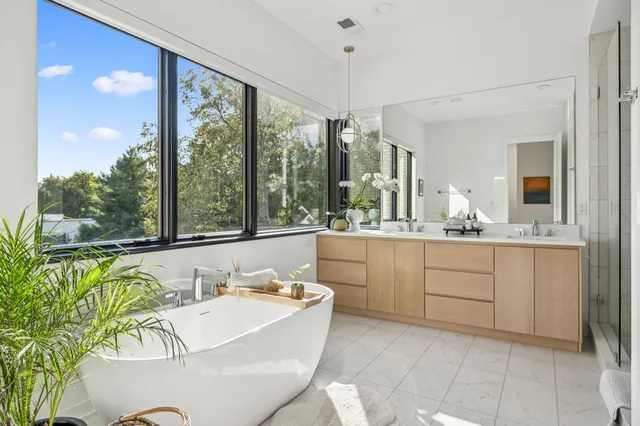 a bathroom with a granite countertop sink and a large mirror