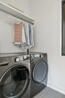 a living room with furniture a flat screen tv and a wall