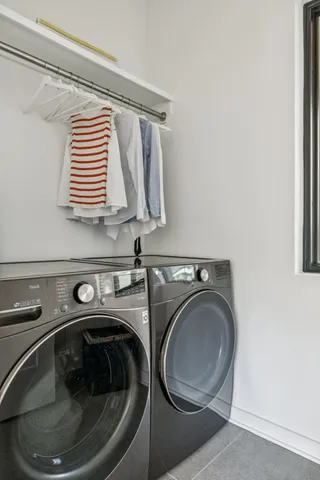 a living room with furniture a flat screen tv and a wall