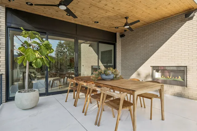 a view of an outdoor dining space with a table and chairs