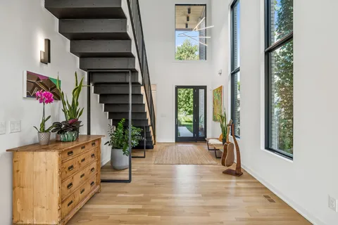 a view of an entryway with wooden floor and windows