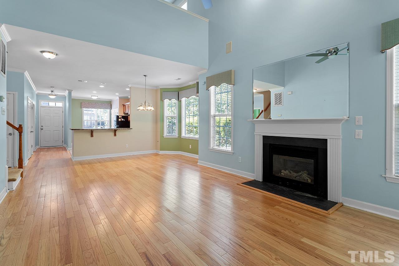 844 Horton Road, Unit 64 Durham, NC 27704 - Photo 13 of 25 a view of a kitchen and an empty room with wooden floor