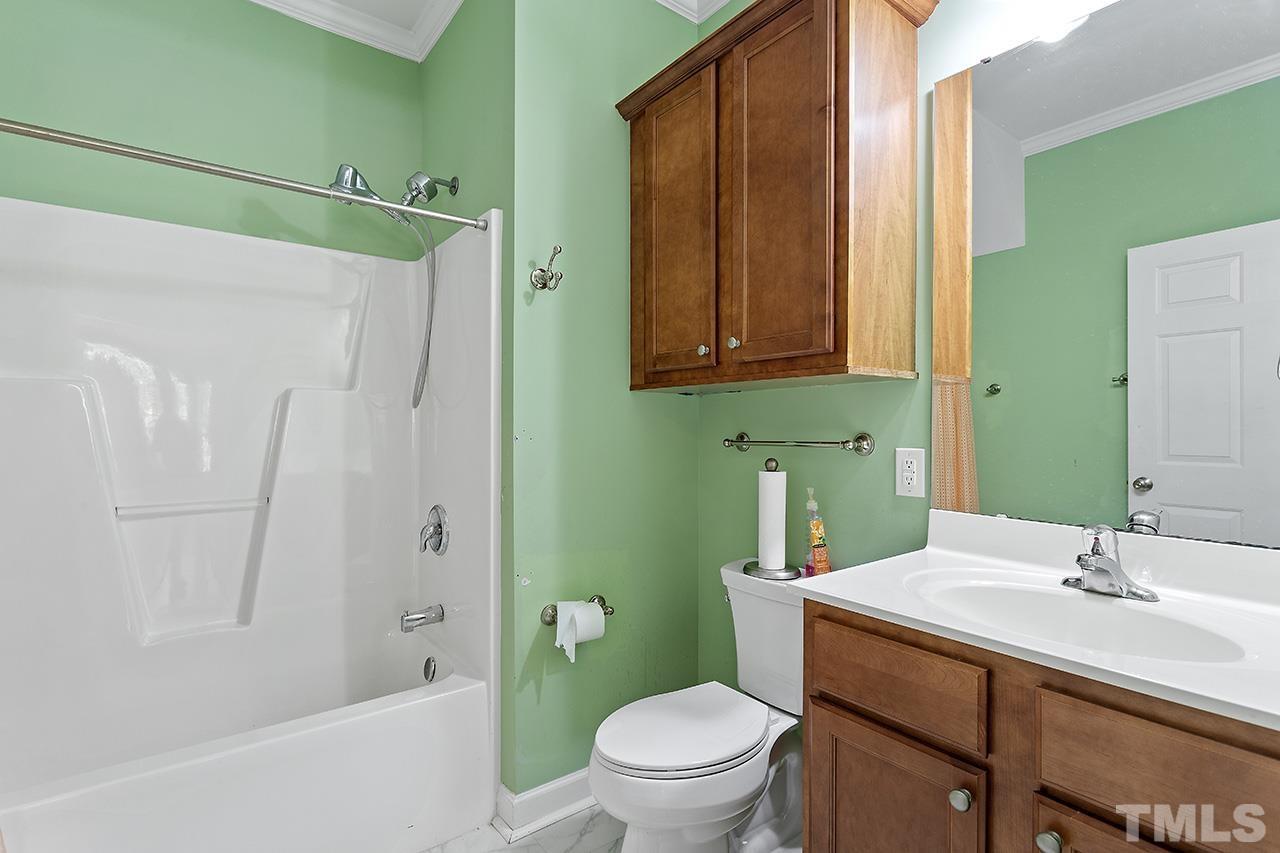 844 Horton Road, Unit 64 Durham, NC 27704 - Photo 18 of 25 a bathroom with a sink a toilet and shower