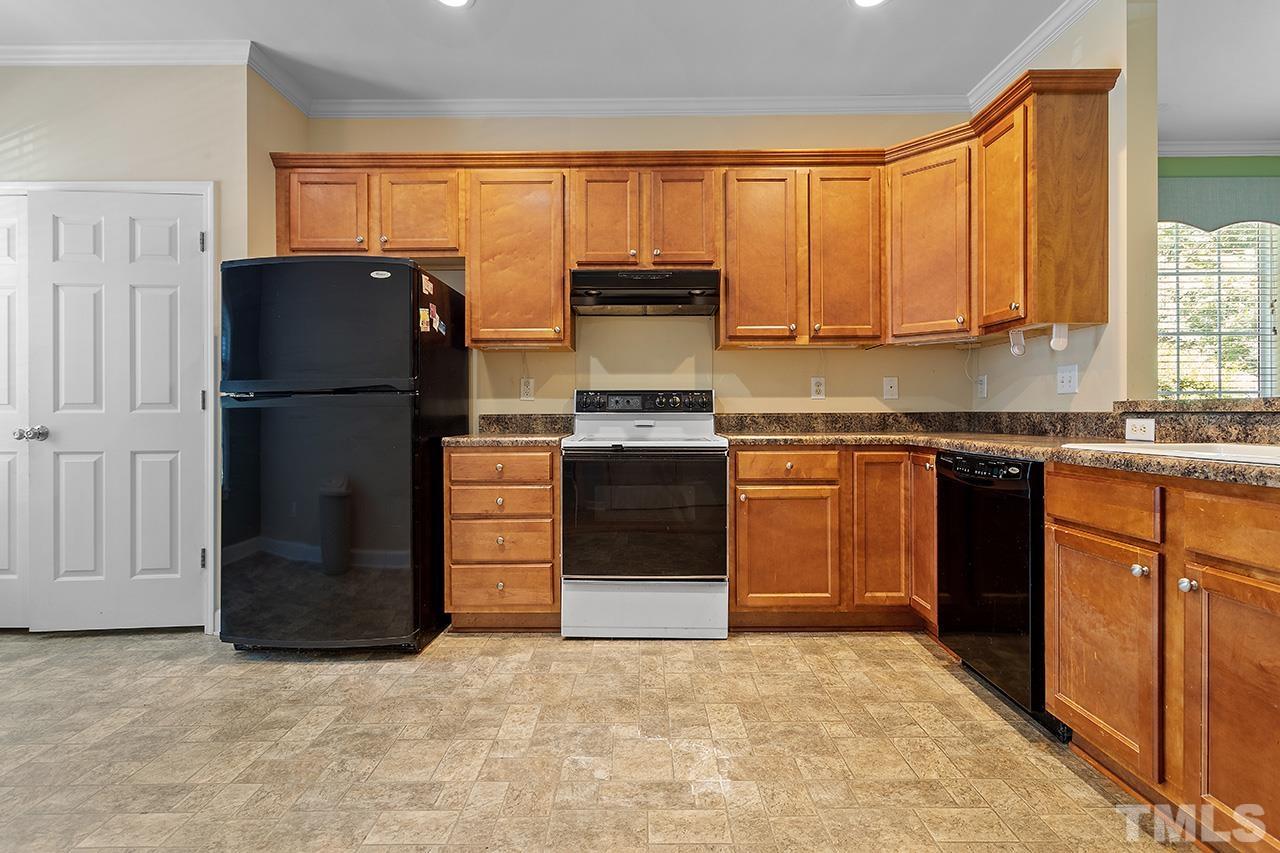 844 Horton Road, Unit 64 Durham, NC 27704 - Photo 3 of 25 a kitchen with stainless steel appliances granite countertop a refrigerator and a stove top oven