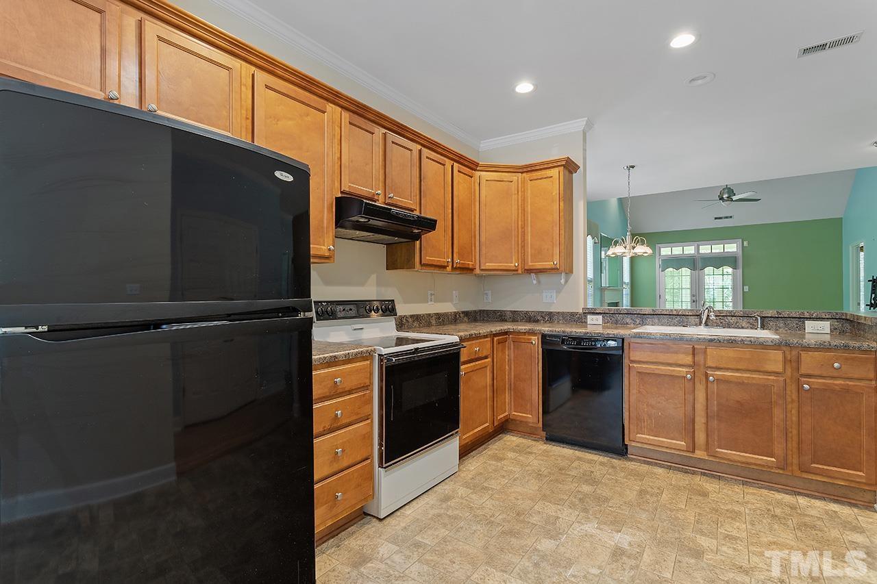 844 Horton Road, Unit 64 Durham, NC 27704 - Photo 4 of 25 a kitchen with stainless steel appliances granite countertop a refrigerator and a sink