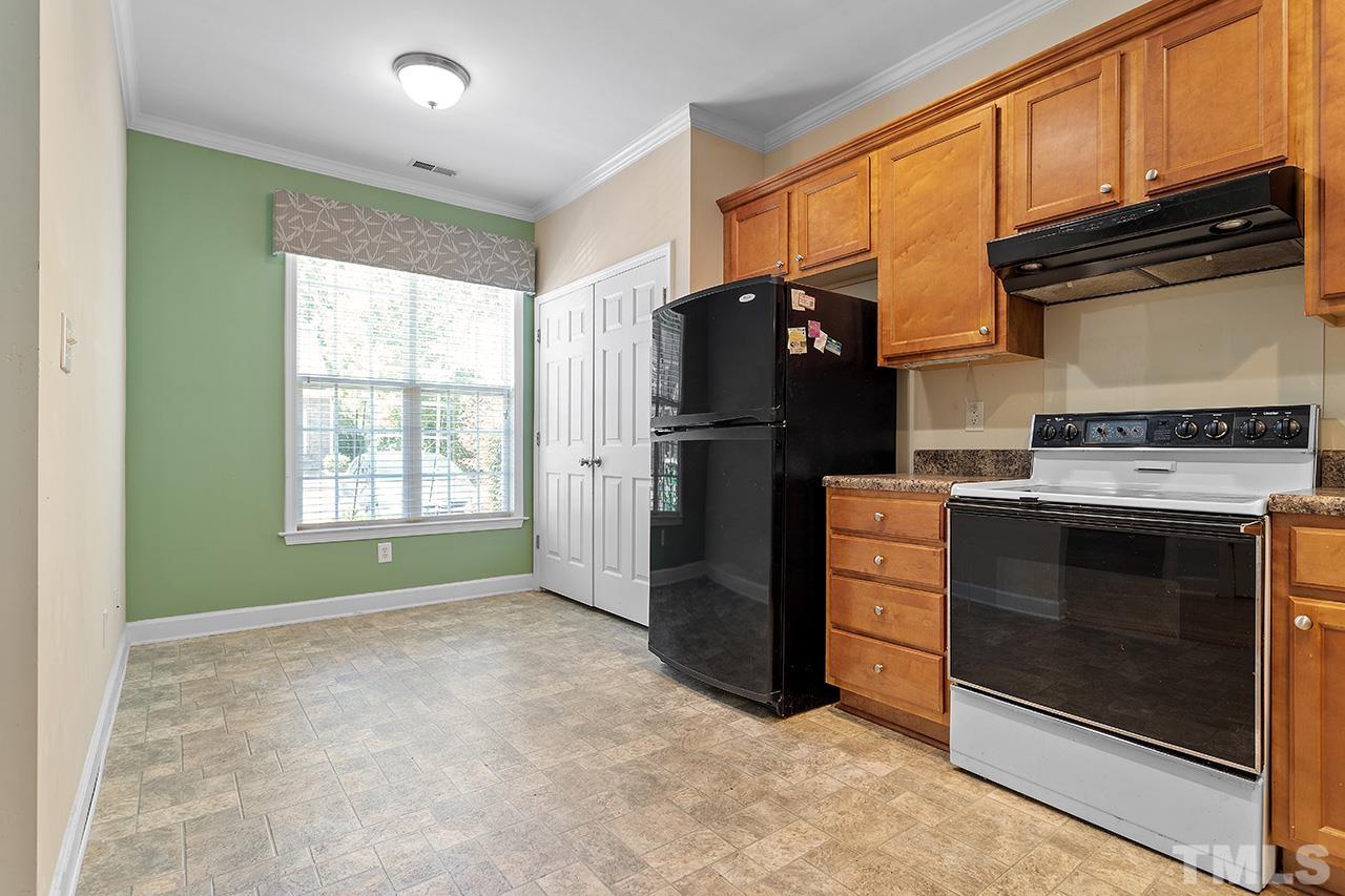 844 Horton Road, Unit 64 Durham, NC 27704 - Photo 5 of 25 a kitchen with a refrigerator and a stove