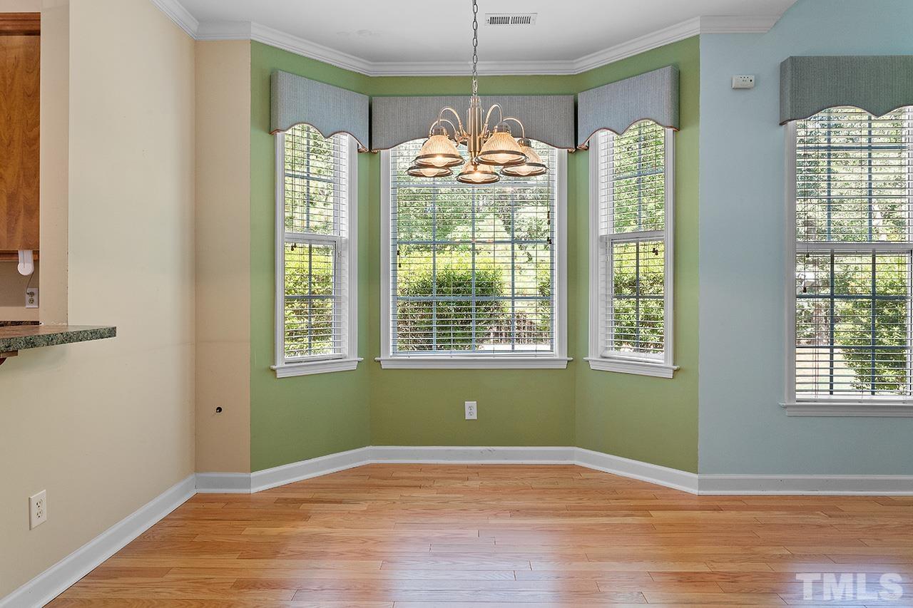 844 Horton Road, Unit 64 Durham, NC 27704 - Photo 9 of 25 a view of an empty room with wooden floor and a window