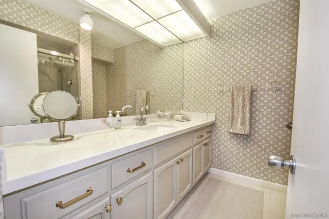 a bathroom with a sink double vanity and a mirror