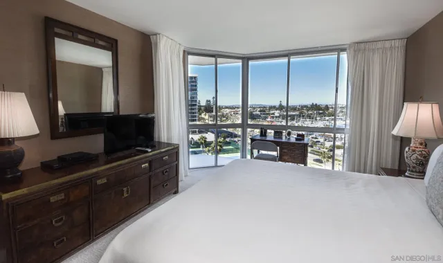 a kitchen with a large window and a view of living room