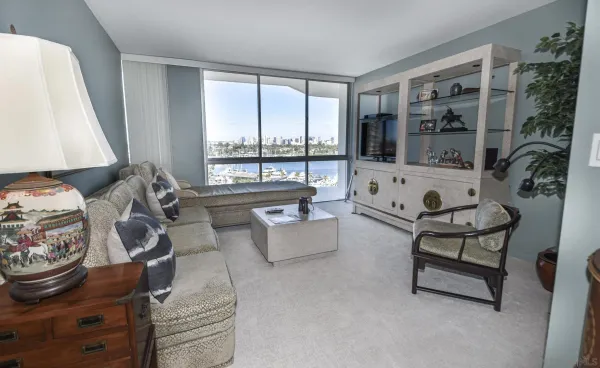 a living room with furniture and a floor to ceiling window