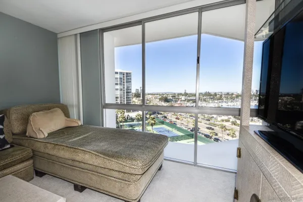a bedroom with a bed and large window