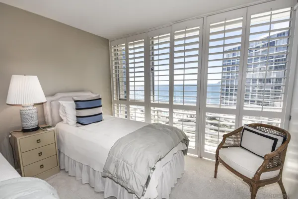 a bedroom with a bed and a large window
