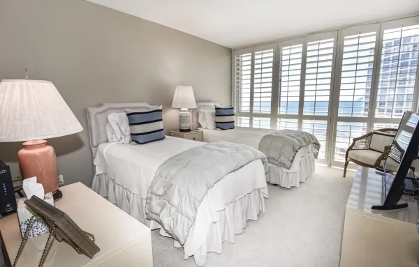 a spacious bedroom with two beds and a large window