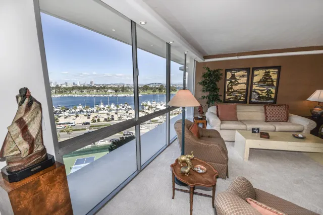 a living room with furniture and a floor to ceiling window