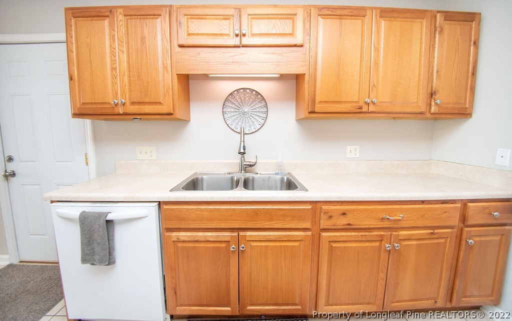 102 Duncan Road Spring Lake, NC 28390 - Photo 11 of 25 a kitchen with stainless steel appliances granite countertop white cabinets and a sink
