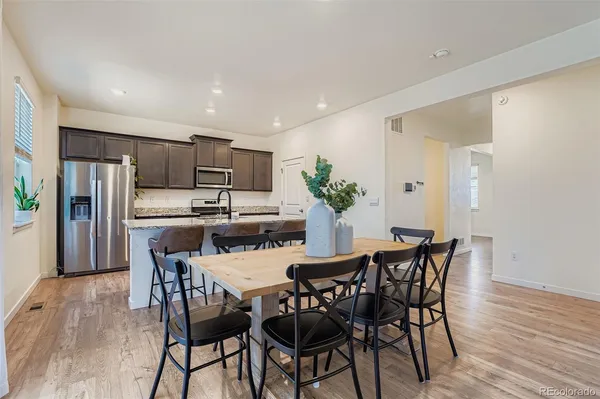 a view of a dining room with furniture and wooden floor