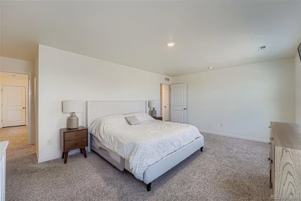 a bedroom with a bed and a night stand