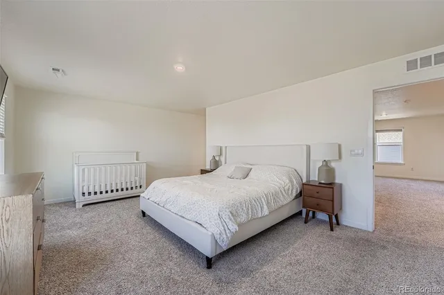 a bedroom with a bed and a lamp