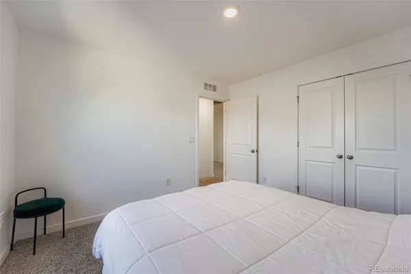 a bedroom with a bed and a chair