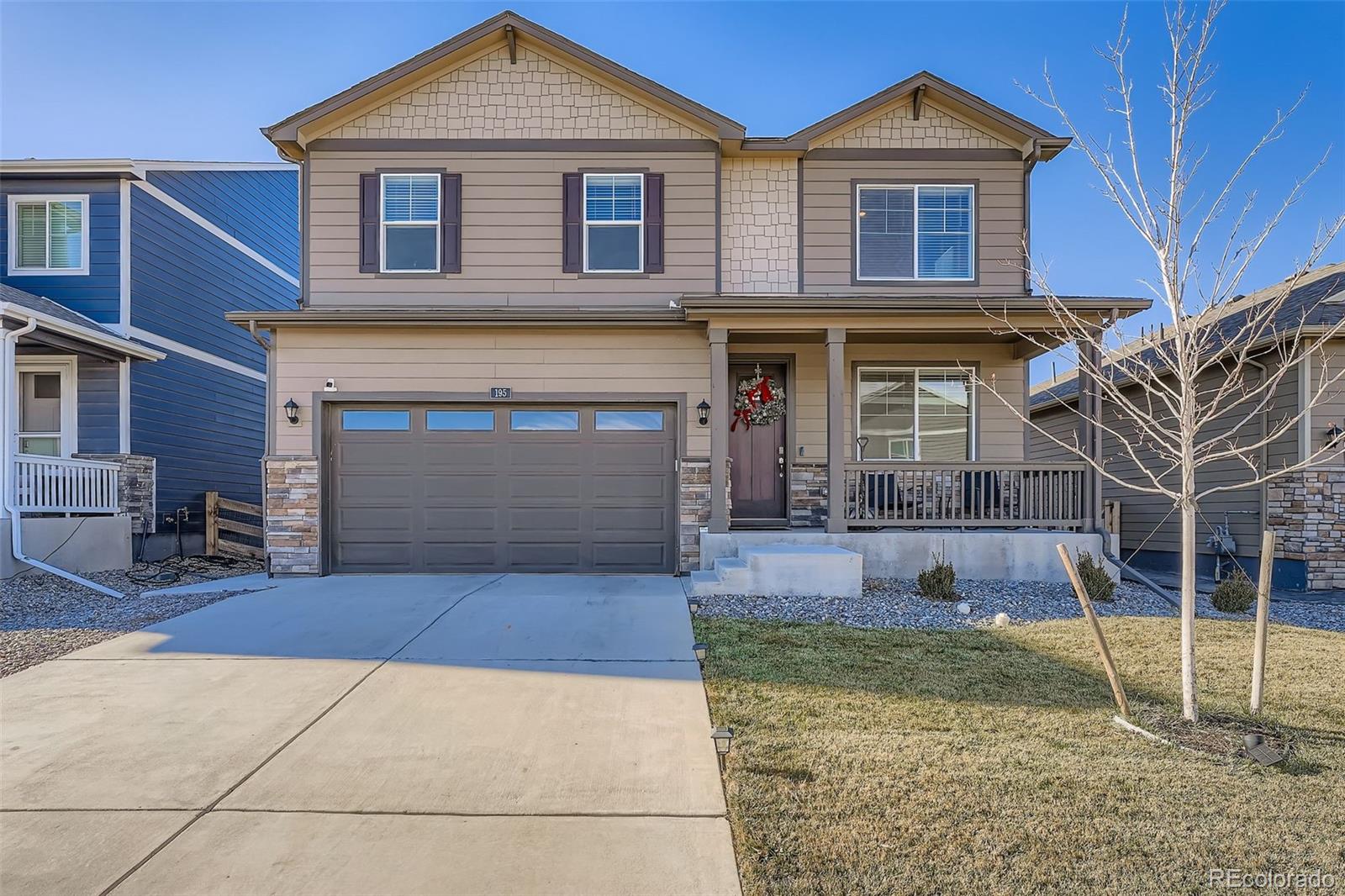 195 Yellowtail Street Bennett, CO 80102 - Photo 2 of 31 a front view of a house with a yard and garage