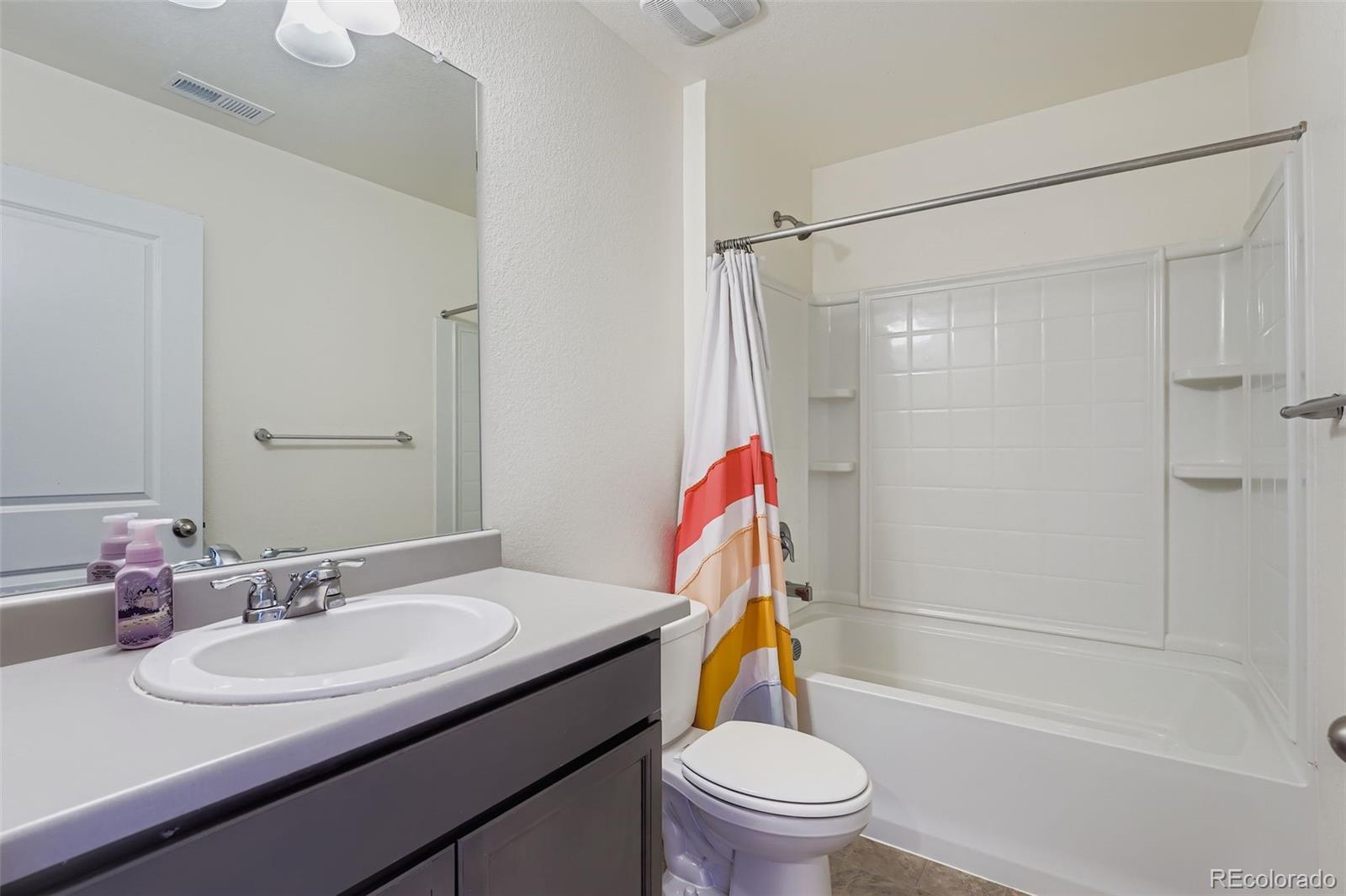 195 Yellowtail Street Bennett, CO 80102 - Photo 22 of 31 a bathroom with a sink toilet and shower
