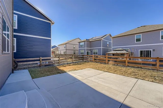 a view of a house with wooden fence
