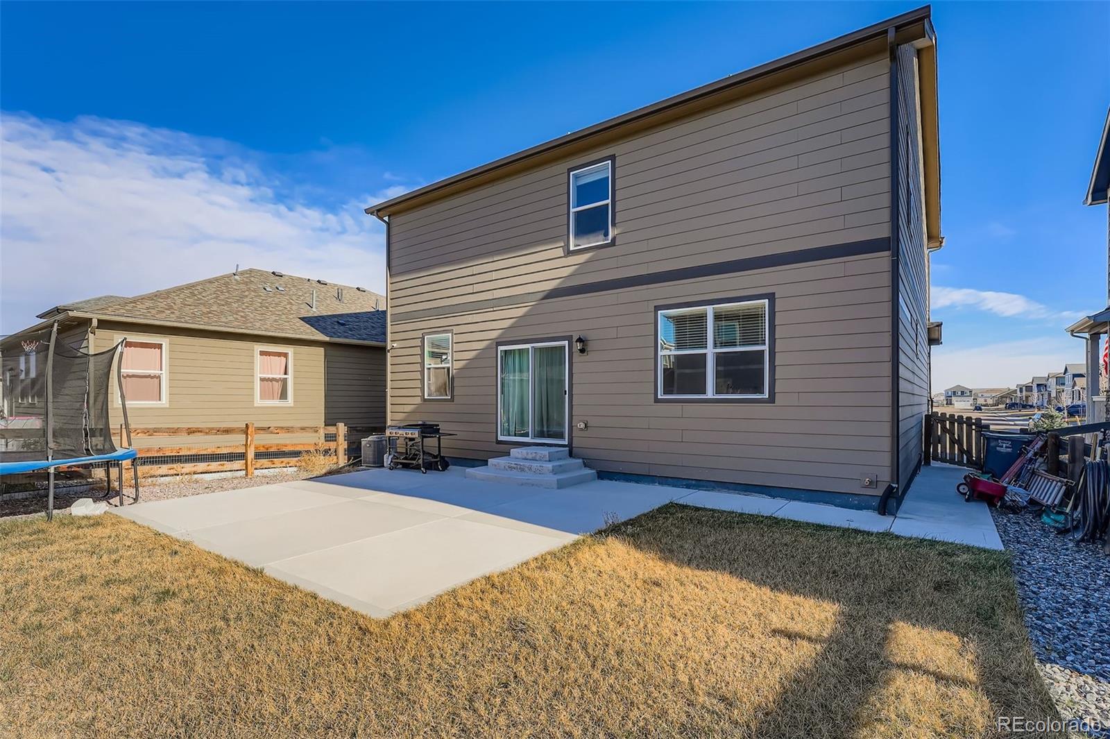 195 Yellowtail Street Bennett, CO 80102 - Photo 28 of 31 a view of a house with a patio