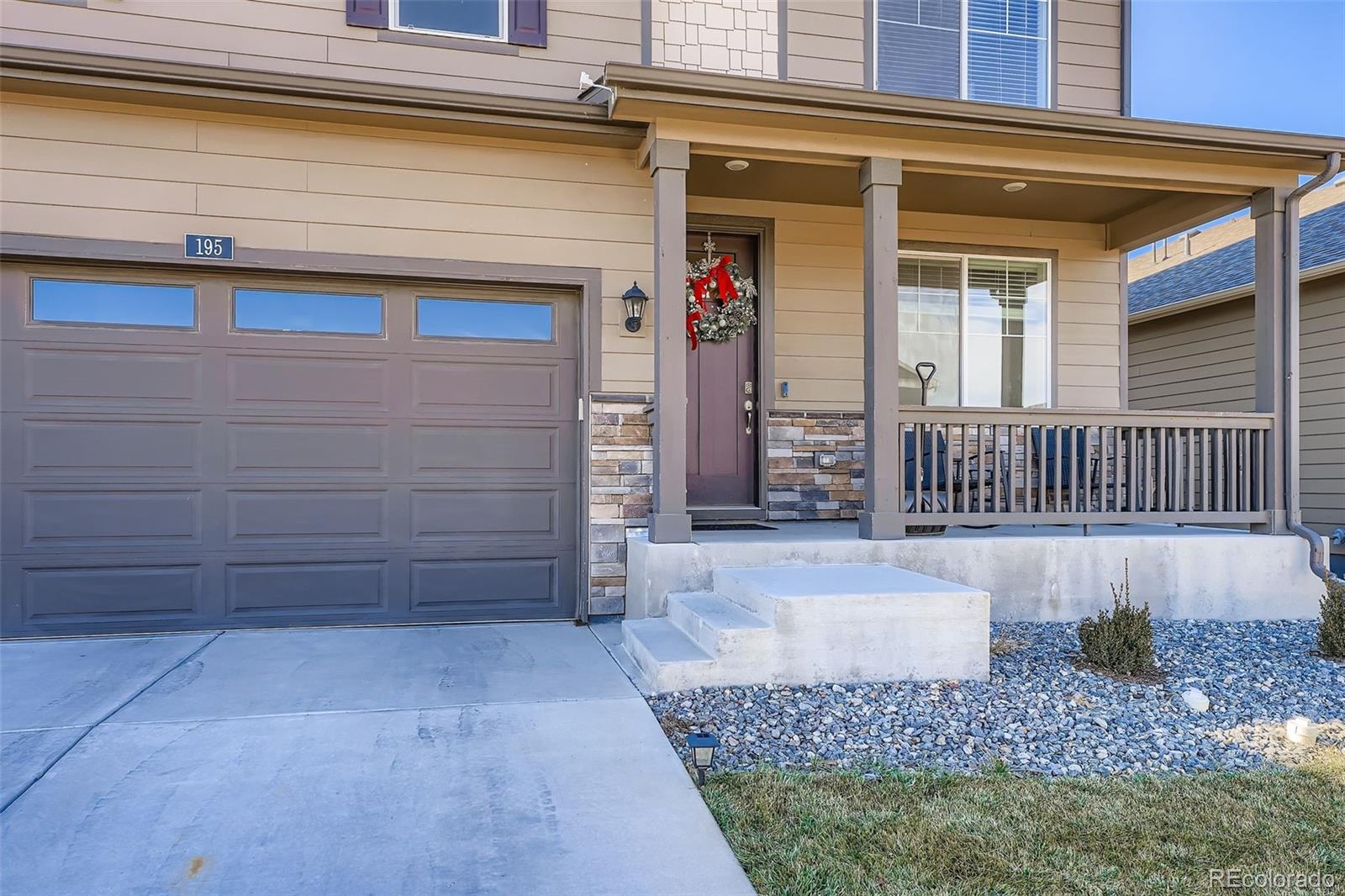 195 Yellowtail Street Bennett, CO 80102 - Photo 3 of 31 a view of a house with a small yard and wooden floor and fence