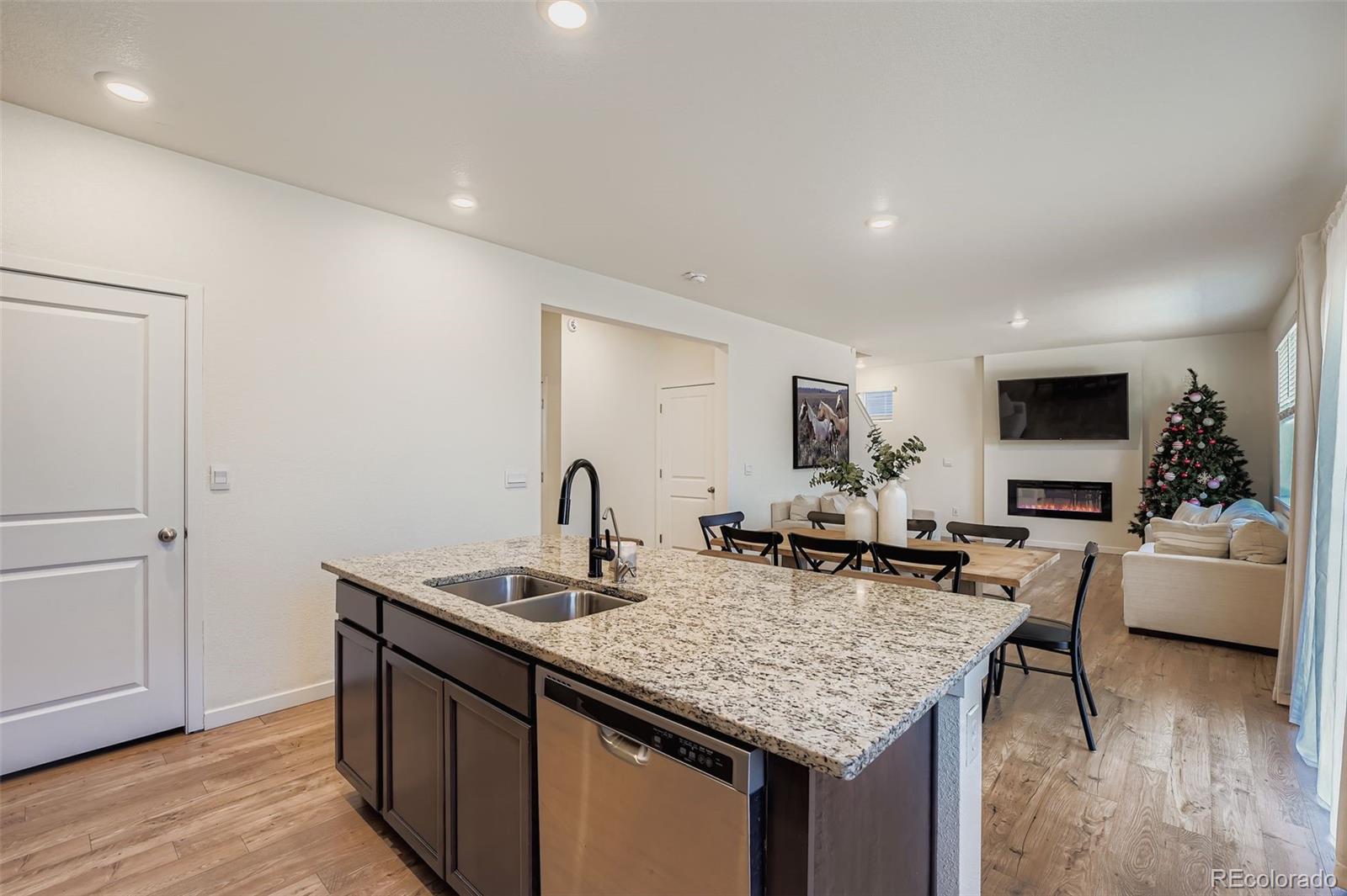 195 Yellowtail Street Bennett, CO 80102 - Photo 9 of 31 a kitchen with center island and stainless steel appliances