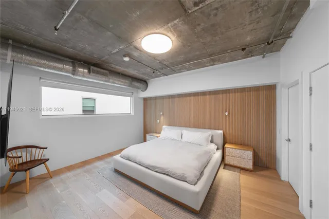 a bedroom with a bed and a table