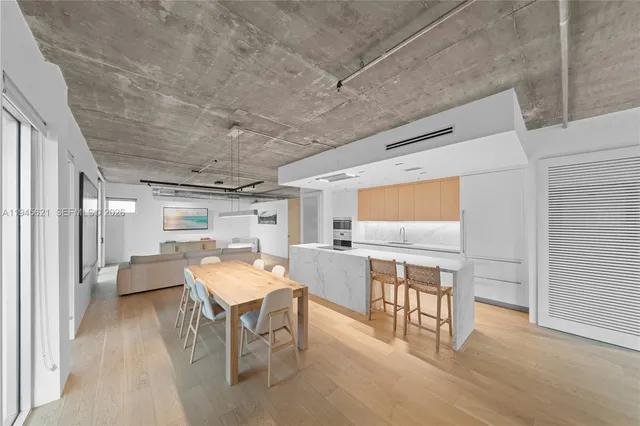 a dining room with furniture and wooden floor