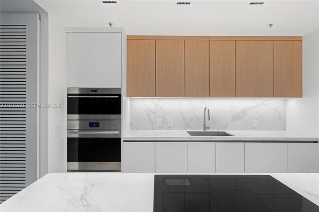 a kitchen with a sink and cabinets