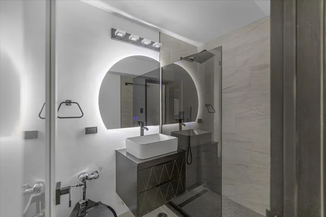 a bathroom with a sink vanity and a mirror