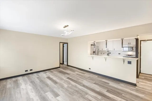 a view of kitchen with cabinets and wooden floor