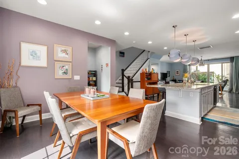 a dining room with stainless steel appliances kitchen island a table and chairs