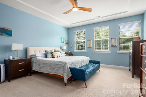 a spacious bedroom with a bed and a window