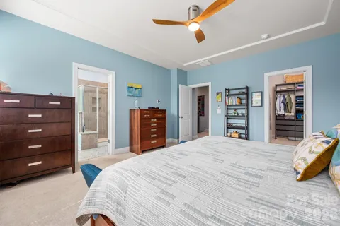 a bedroom with a bed a dresser and book shelf