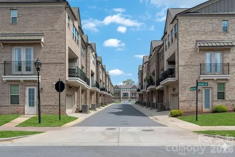a view of a street in front of a brick building