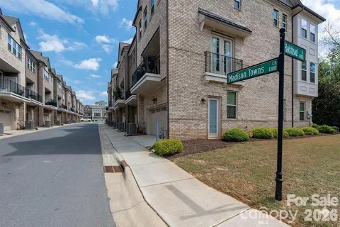 a view of a street with brick building in the background